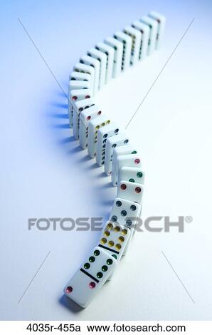 Stock Image - Row of dominos tumbling. Fotosearch