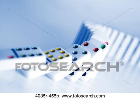 Stock Image - Row of dominos tumbling. Fotosearch