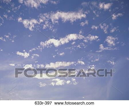 Scattered white clouds in the sky View Large Photo Image Stock Photo - Scattered white clouds in the sky. Fotosearch