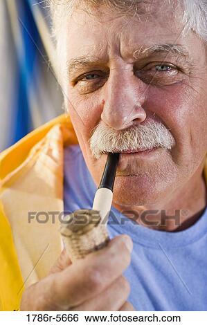 Stock Photograph - Senior man smoking pipe. Fotosearch