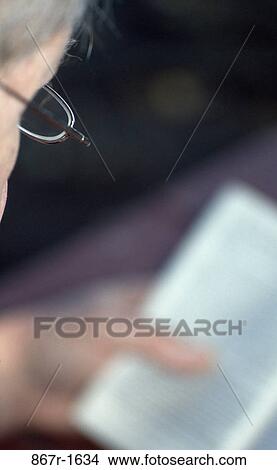 Picture - Senior person reading a book. Fotosearch