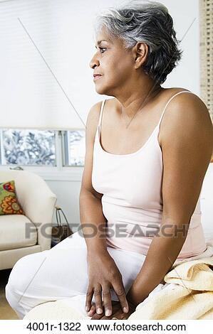 Senior woman thinking on the bed View Large Photo Image Stock Image - Senior woman thinking on the bed. Fotosearch