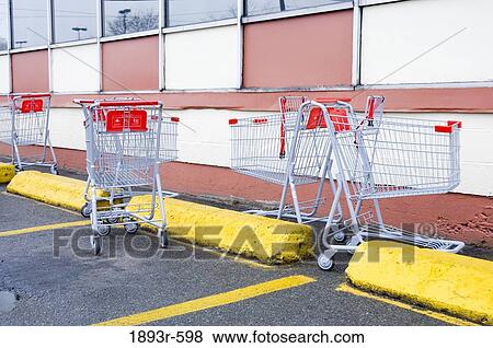 shopping carts randomly scattered in a supermarket parking lot View Large Photo Image Stock Photo - shopping carts randomly scattered in a supermarket parking lot. Fotosearch