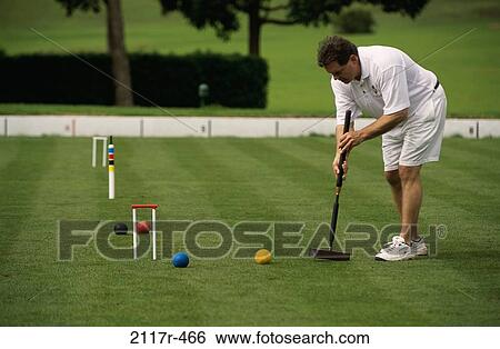 Side profile of a mid adult man playing croquet View Large Photo Image Stock Photograph - Side profile of a mid adult man playing croquet. Fotosearch