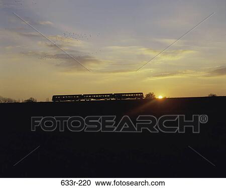 Stock Image - Silhouette of a commuter train, Edinburgh, Scotland. Fotosearch