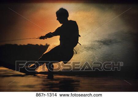 Silhouette of a man water skiing View Large Photo Image Picture - Silhouette of a man water skiing. Fotosearch