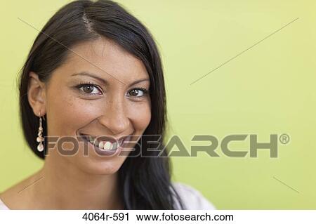 Stock Image - Studio portrait of businesswoman smiling. Fotosearch