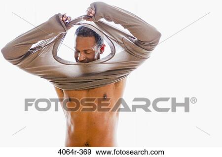 Studio portrait of man getting dressed View Large Photo Image Stock Photo - Studio portrait of man getting dressed. Fotosearch