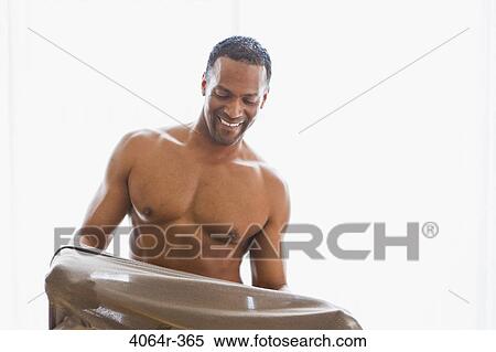 Studio portrait of man getting dressed View Large Photo Image Stock Photography - Studio portrait of man getting dressed. Fotosearch