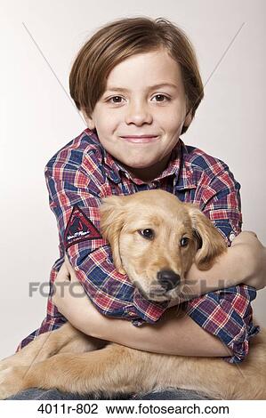 Studio portrait of smiling boy hugging puppy View Large Photo Image Stock Image - Studio portrait of smiling boy hugging puppy. Fotosearch