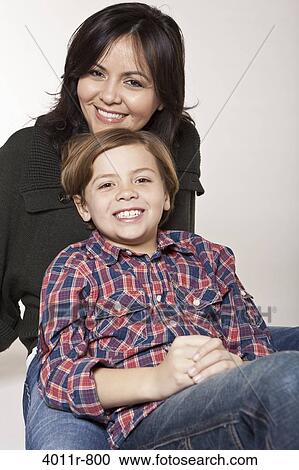 Studio portrait of smiling woman with son View Large Photo Image Stock Image - Studio portrait of smiling woman with son. Fotosearch