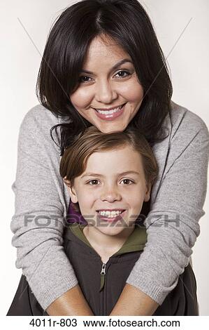 Studio portrait of smiling woman with son View Large Photo Image Stock Image - Studio portrait of smiling woman with son. Fotosearch
