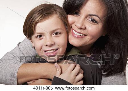 Studio portrait of smiling woman with son View Large Photo Image Stock Photography - Studio portrait of smiling woman with son. Fotosearch