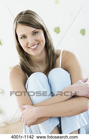 Studio portrait of young woman smiling View Large Photo Image Stock Image - Studio portrait of young woman smiling. Fotosearch