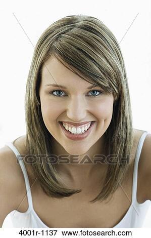 Studio portrait of young woman smiling View Large Photo Image Stock Photo - Studio portrait of young woman smiling. Fotosearch