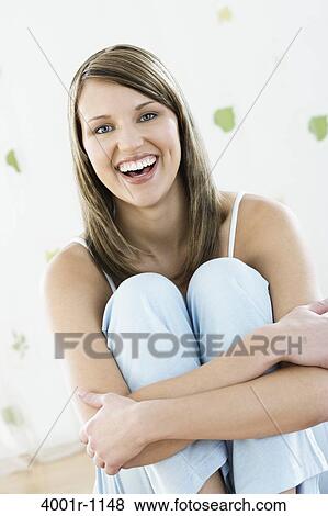 Studio portrait of young woman smiling View Large Photo Image Stock Photo - Studio portrait of young woman smiling. Fotosearch