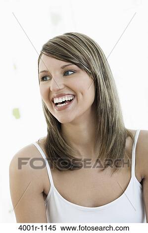 Studio portrait of young woman smiling View Large Photo Image Stock Photography - Studio portrait of young woman smiling. Fotosearch