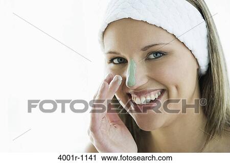 Studio portrait of young woman with cream on nose, smiling View Large Photo Image Stock Image - Studio portrait of young woman with cream on nose, smiling. Fotosearch