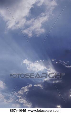 Sun shining behind clouds in the sky View Large Photo Image Stock Photography - Sun shining behind clouds in the sky. Fotosearch
