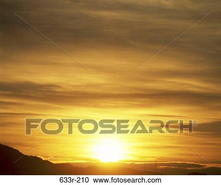 Stock Image - Sunset over a landscape. Fotosearch