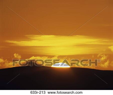 Stock Image - Sunset over a landscape. Fotosearch