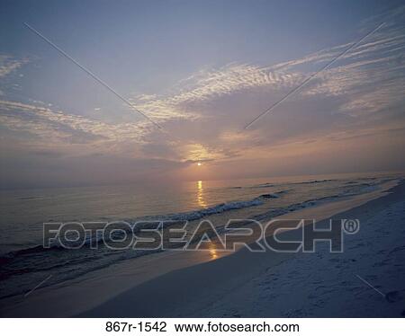 Stock Image - Sunset over the ocean, Panama City Beach, Florida, USA. Fotosearch