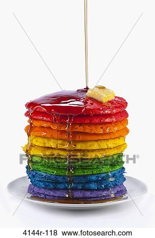 Syrup being poured on rainbow colored pancakes View Large Photo Image Stock Photo - Syrup being poured on rainbow colored pancakes. Fotosearch