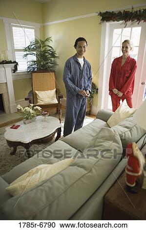 Teenage boy with his mother in pajamas standing in living room View Large Photo Image Stock Image - Teenage boy with his mother in pajamas standing in living room. Fotosearch