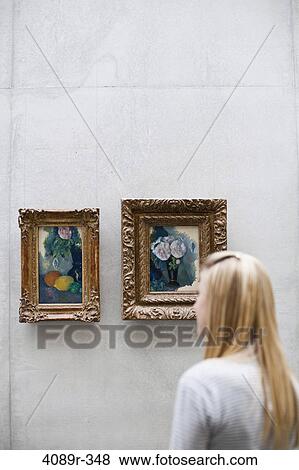 Teenage girl looking at paintings in a museum View Large Photo Image Stock Photo - Teenage girl looking at paintings in a museum. Fotosearch
