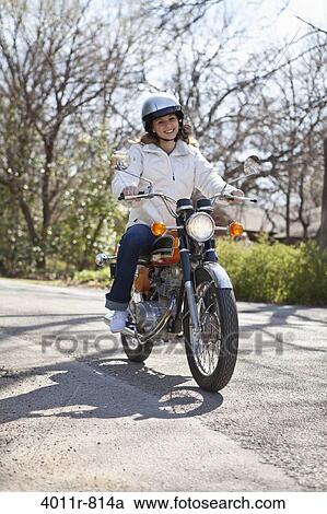 Teenage girl riding motorcycle View Large Photo Image Stock Image - Teenage girl riding motorcycle. Fotosearch