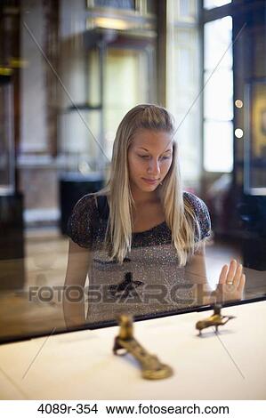 Teenage girl watching Egyptian relics in a museum, Paris, Ile-de-France, France View Large Photo Image Picture - Teenage girl watching Egyptian relics in a museum, Paris, Ile-de-France, France. Fotosearch