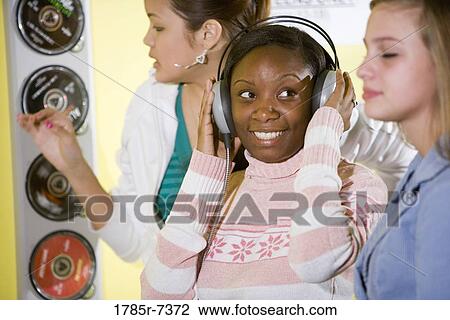 Teenage girls listening to music View Large Photo Image Stock Image - Teenage girls listening to music. Fotosearch