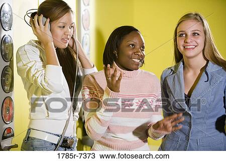 Teenage girls listening to music View Large Photo Image Stock Image - Teenage girls listening to music. Fotosearch