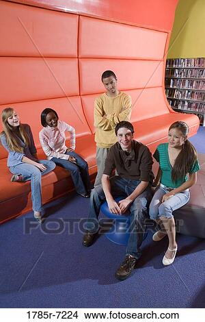 Teenagers hanging out in school library View Large Photo Image Picture - Teenagers hanging out in school library. Fotosearch