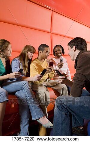 Teenagers with their cell phones View Large Photo Image Stock Image - Teenagers with their cell phones. Fotosearch