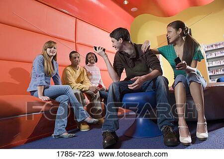 Teenagers with their cell phones View Large Photo Image Stock Image - Teenagers with their cell phones. Fotosearch