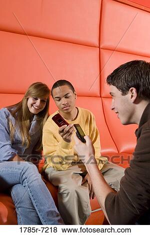 Teenagers with their cell phones View Large Photo Image Stock Photo - Teenagers with their cell phones. Fotosearch