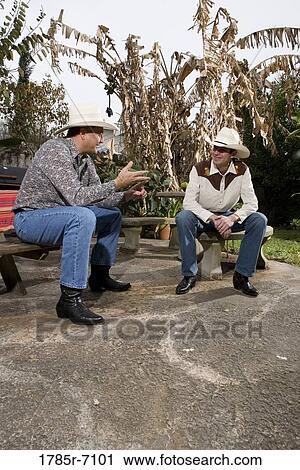 Tex-Mex father and son engaged in conversation in the backyard of their house View Large Photo Image Stock Image - Tex-Mex father and son engaged in conversation in the backyard of their house. Fotosearch