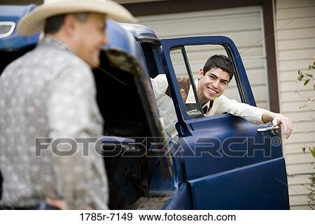 Tex-Mex father and son next to pickup truck View Large Photo Image Stock Photo - Tex-Mex father and son next to pickup truck. Fotosearch