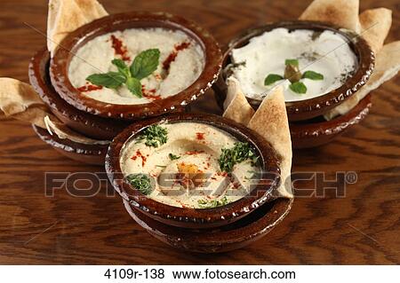 Three bowls of dips with pita slices View Large Photo Image Stock Photo - Three bowls of dips with pita slices. Fotosearch