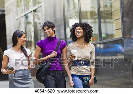 Three businesswomen walking outside office View Large Photo Image Stock Image - Three businesswomen walking outside office. Fotosearch