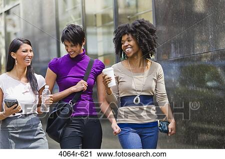 Three businesswomen walking outside office View Large Photo Image Stock Image - Three businesswomen walking outside office. Fotosearch