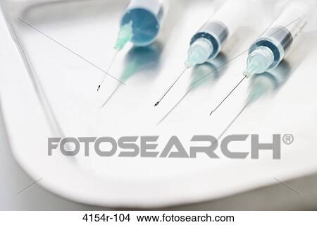 Three surgical needles in kidney tray View Large Photo Image Picture - Three surgical needles in kidney tray. Fotosearch