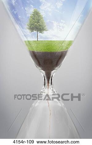 Tree growing inside hour glass View Large Photo Image Stock Photo - Tree growing inside hour glass. Fotosearch