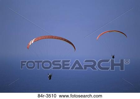 Stock Image - Two people parasailing. Fotosearch
