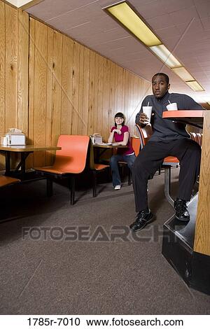 Two young people in a diner View Large Photo Image Stock Image - Two young people in a diner. Fotosearch