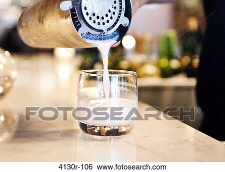 USA, New York City, Manhattan, pouring pisco sour from shaker to glass View Large Photo Image Stock Photograph - USA, New York City, Manhattan, pouring pisco sour from shaker to glass. Fotosearch