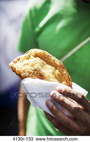 USA, New York State, New York City, Hester Street Market, La Sonrisa, Man holding Empananda View Large Photo Image Stock Image - USA, New York State, New York City, Hester Street Market, La Sonrisa, Man holding Empananda. Fotosearch