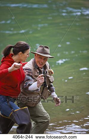 USA, Washington, Vancouver, Couple skipping stones on river View Large Photo Image Picture - USA, Washington, Vancouver, Couple skipping stones on river. Fotosearch