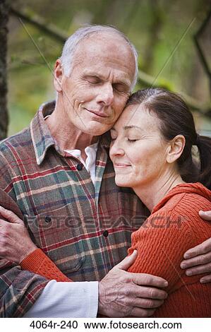 Stock Image - USA, Washington, Vancouver, Couple embracing outdoors. Fotosearch